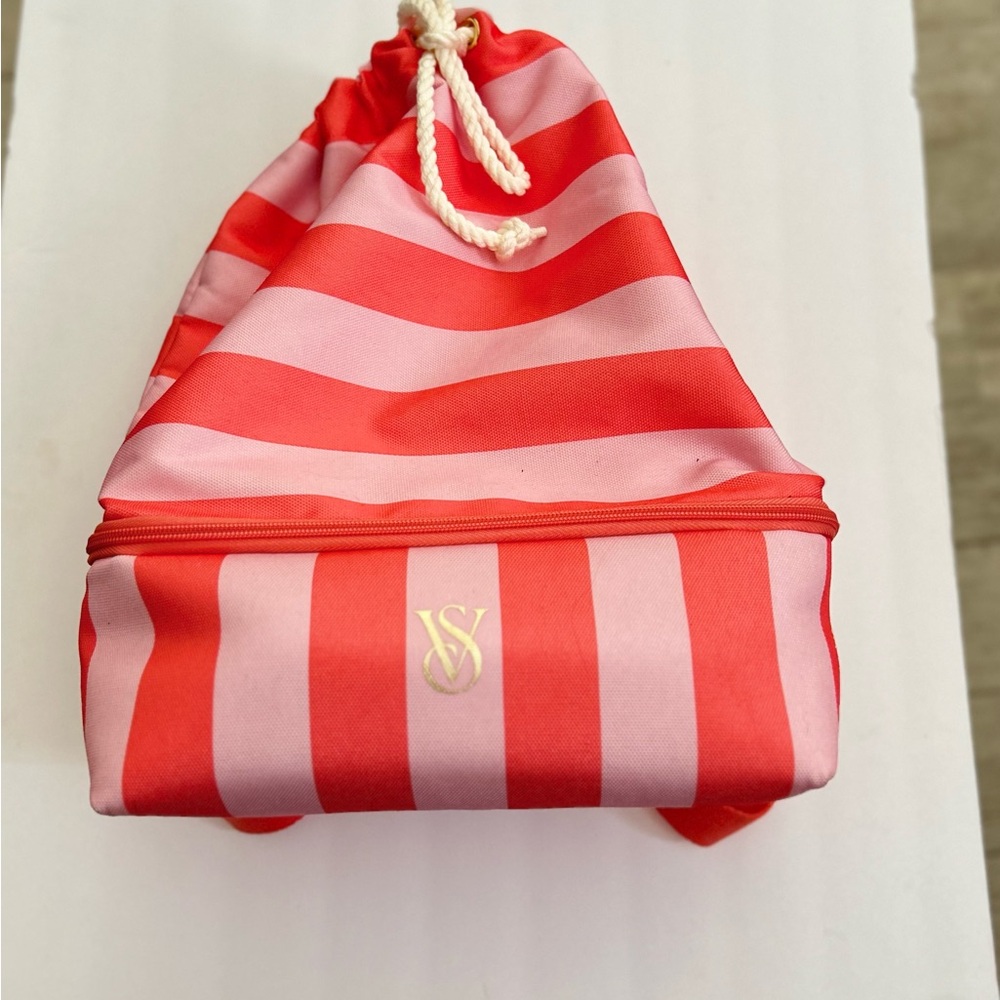 Beach bag with cooler pouch. Pink and orange, has zipper and drawstring.